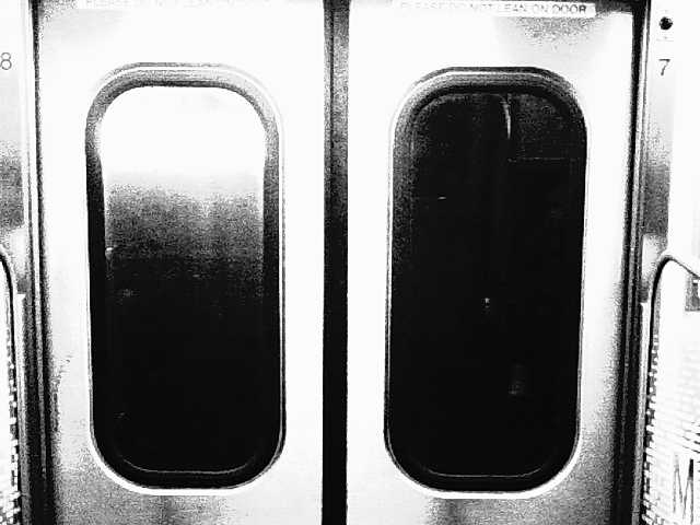 Black and white video of the metro train window and lights going by